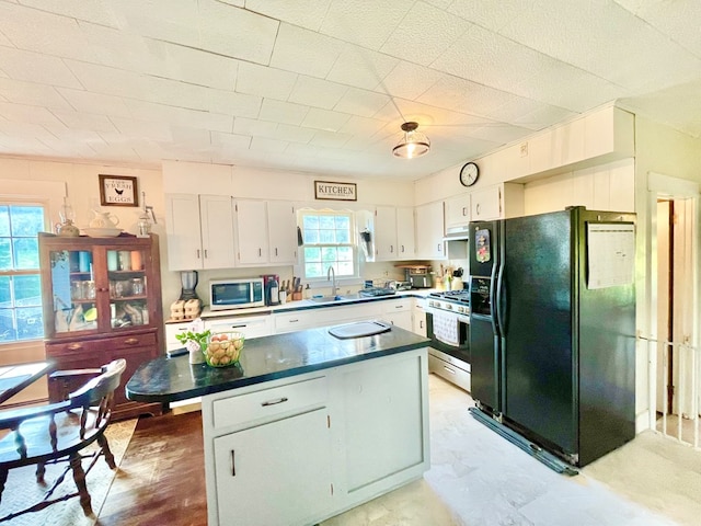 403 Horse Thief Run Rd, Wellsboro, PA 16901 - kitchen with stainless steel appliances, white cabinets, a sink, dark countertops, and a center island