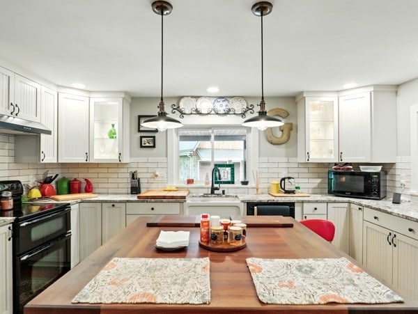 175 Rte 467, Wysox, PA 18854 - kitchen with black appliances, under cabinet range hood, tasteful backsplash, a sink, and a kitchen island