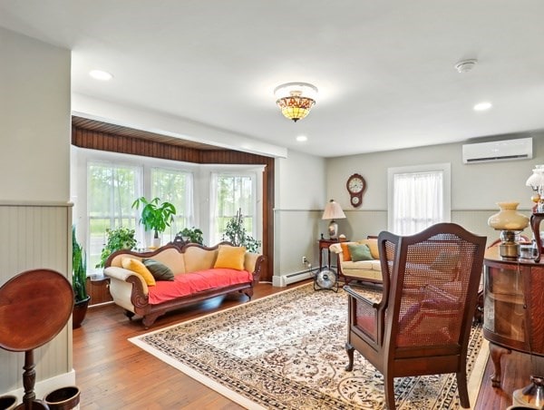 175 Rte 467, Wysox, PA 18854 - living area with an AC wall unit, wood finished floors, a baseboard heating unit, and recessed lighting