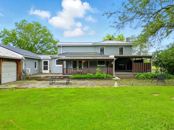 175 Rte 467, Wysox, PA 18854 - back of house featuring a lawn, a garage, and metal roof