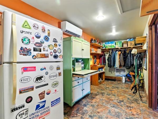 175 Rte 467, Wysox, PA 18854 - kitchen featuring freestanding refrigerator, a wall mounted AC, dark stone finish floors, and open shelves