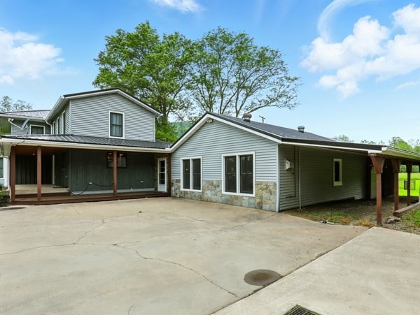 175 Rte 467, Wysox, PA 18854 - rear view of house featuring concrete driveway, covered porch, and stone siding