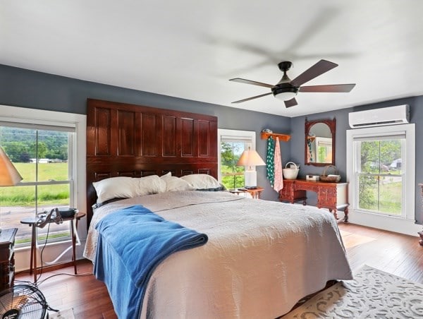 175 Rte 467, Wysox, PA 18854 - bedroom featuring a wall mounted air conditioner, multiple windows, and wood finished floors