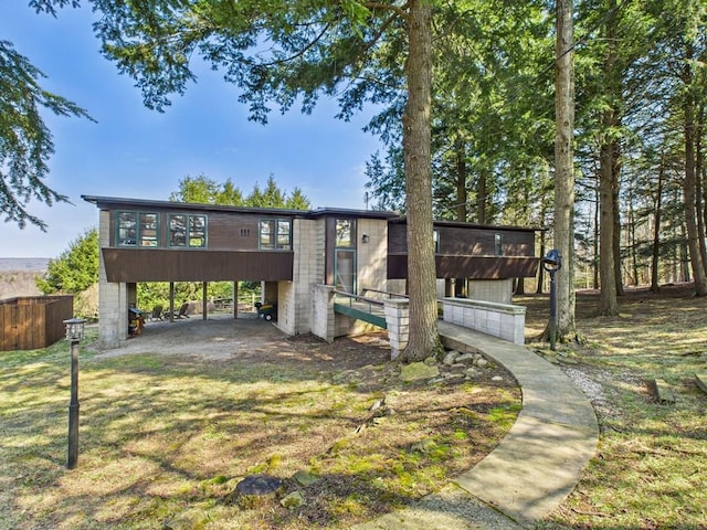 view of property's community with fence and a carport