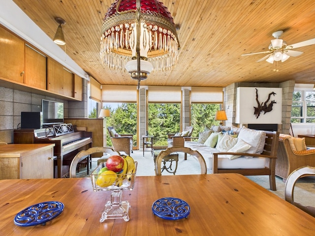 dining area featuring carpet floors, wooden ceiling, and ceiling fan with notable chandelier