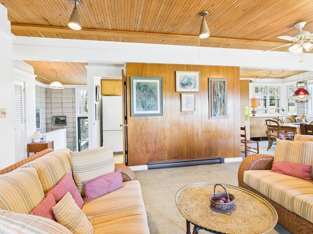 living room with wood ceiling, ceiling fan, baseboard heating, a fireplace, and carpet