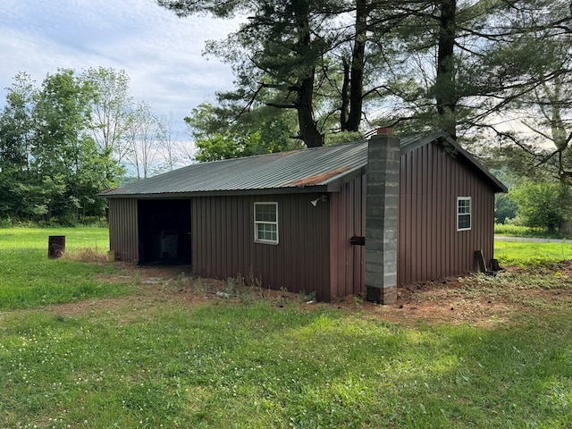 view of outbuilding with a yard