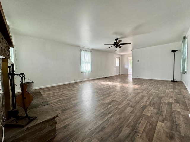 unfurnished living room featuring dark hardwood / wood-style floors and ceiling fan