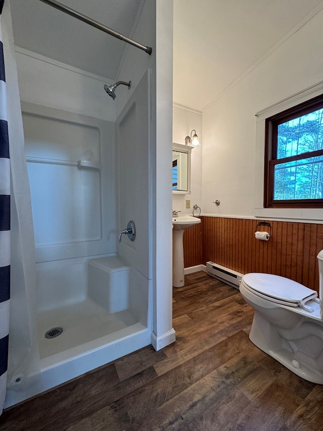 bathroom with walk in shower, a baseboard radiator, toilet, and hardwood / wood-style flooring