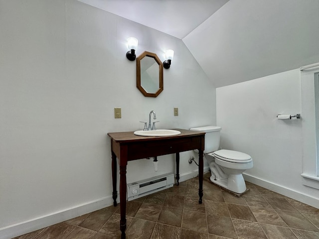 bathroom featuring vaulted ceiling, toilet, sink, and a baseboard heating unit