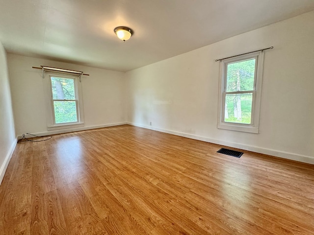 spare room featuring light hardwood / wood-style flooring