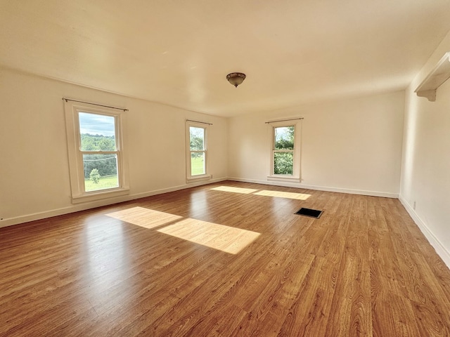 spare room featuring light hardwood / wood-style floors