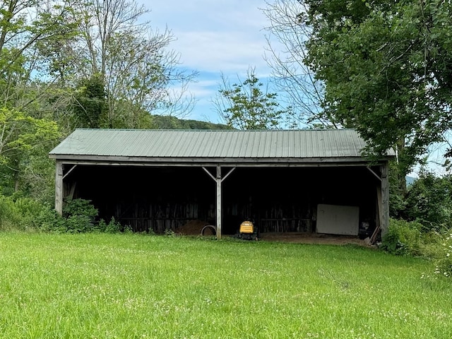 view of outdoor structure featuring a lawn