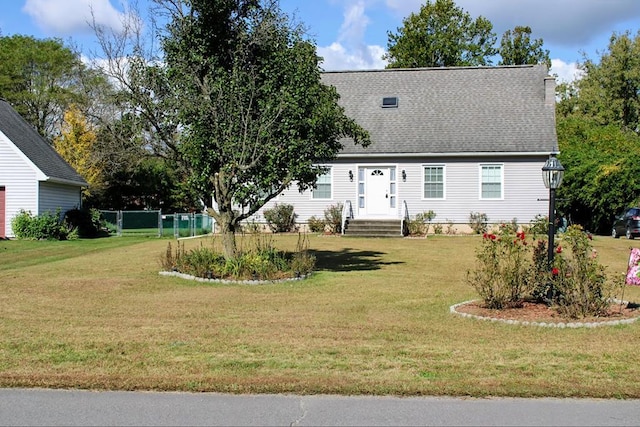 cape cod home featuring a front lawn