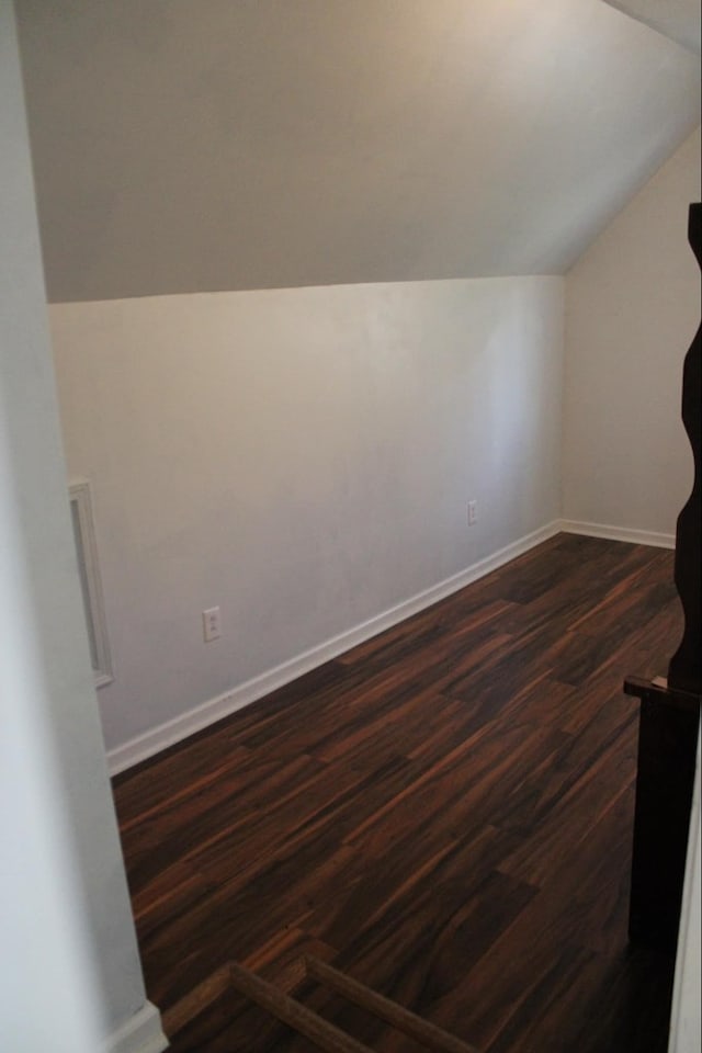 bonus room featuring dark hardwood / wood-style floors and lofted ceiling