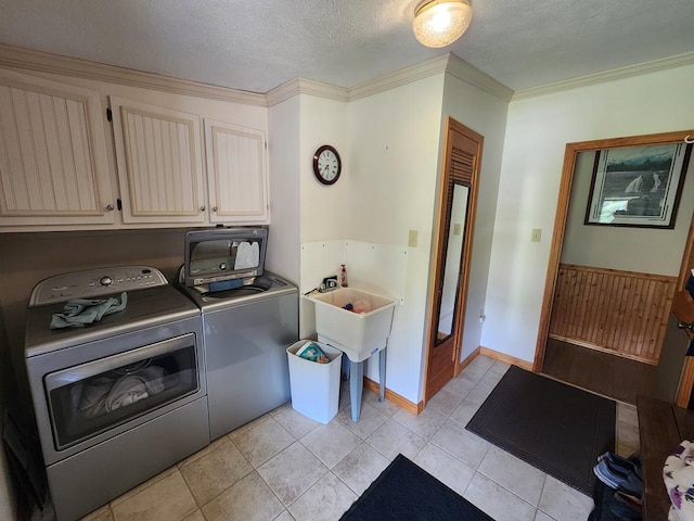 151 Ice Mine Rd, Coudersport, PA 16915 - laundry room featuring cabinet space, washing machine and dryer, a textured ceiling, light tile patterned floors, and ornamental molding