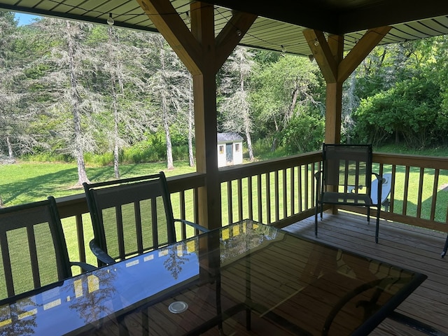 14 Here You Are Ln, Austin, PA 16720 - wooden terrace with a storage unit, outdoor dining area, and a lawn