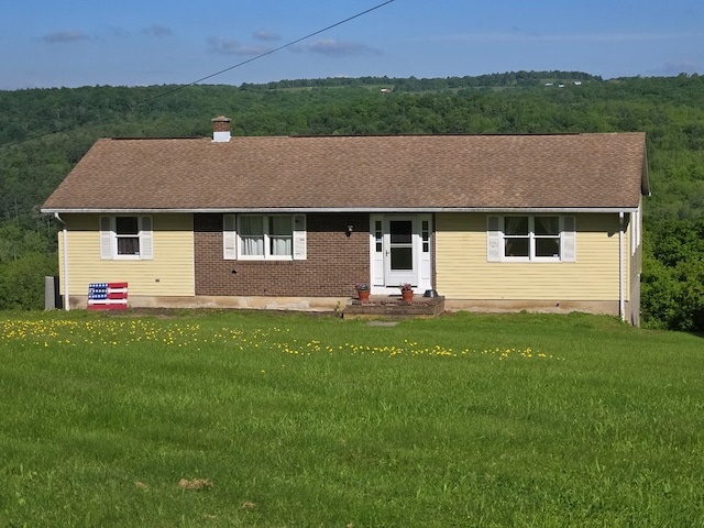 401 Valley View Rd, Wyalusing, PA 18853 - view of front of property featuring a front lawn, a chimney, a shingled roof, and a forest view