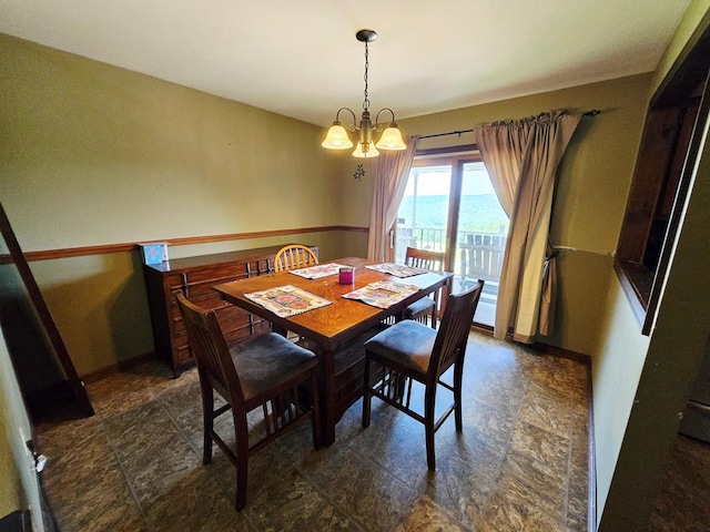 401 Valley View Rd, Wyalusing, PA 18853 - dining room featuring a chandelier and dark stone finish floors