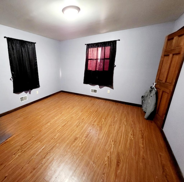 empty room featuring hardwood / wood-style flooring