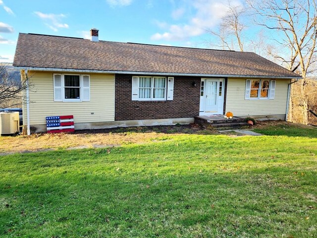 401 Valley View Rd, Wyalusing, PA 18853 - view of front of house featuring a front yard, a chimney, a shingled roof, and brick siding