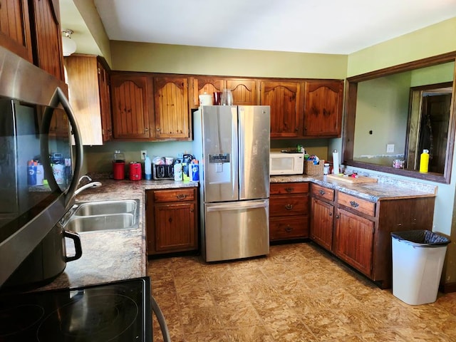 401 Valley View Rd, Wyalusing, PA 18853 - kitchen featuring stainless steel appliances, light countertops, brown cabinets, and a peninsula