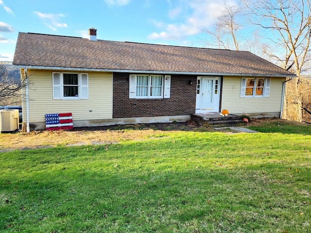 401 Valley View Rd, Wyalusing, PA 18853 - view of front of home featuring central AC, a front yard, a chimney, and a shingled roof