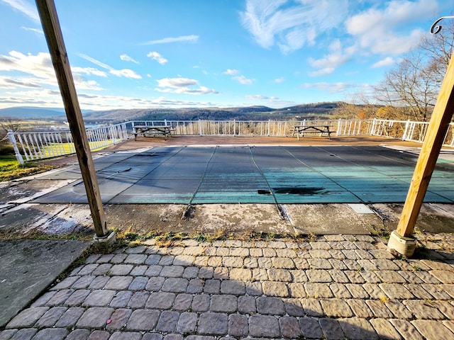 view of pool with a mountain view and a patio