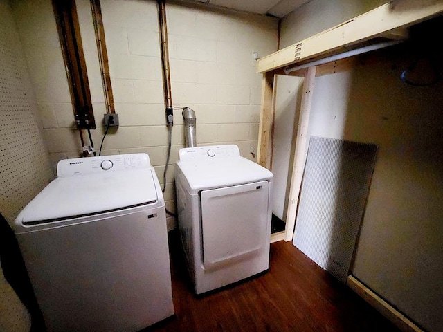 clothes washing area with separate washer and dryer and dark hardwood / wood-style floors