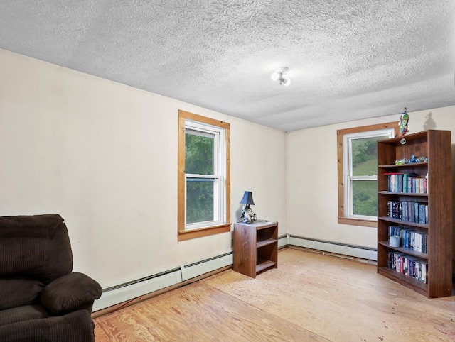135 Middle Rd, Barton, NY 13734 - living area with baseboard heating, wood finished floors, and a textured ceiling