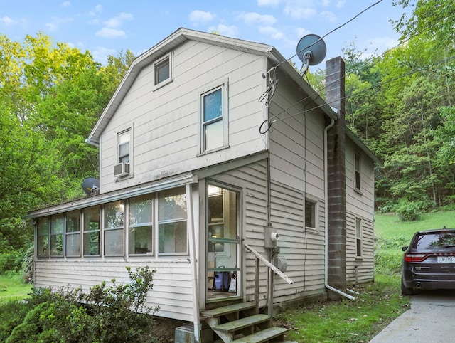 135 Middle Rd, Barton, NY 13734 - view of front of home featuring a chimney, a sunroom, and cooling unit