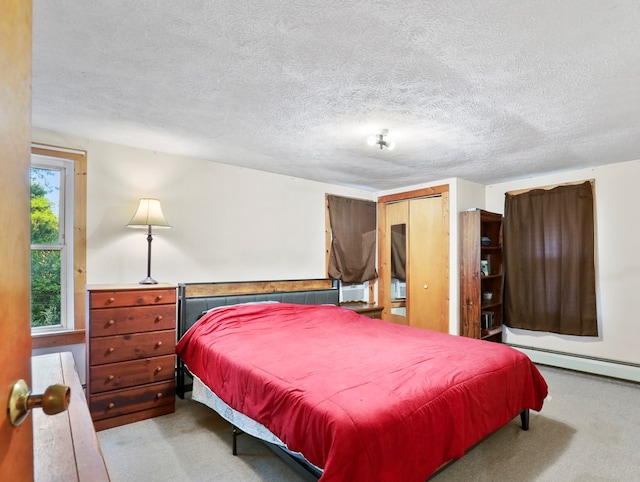 135 Middle Rd, Barton, NY 13734 - carpeted bedroom featuring a textured ceiling and a baseboard heating unit