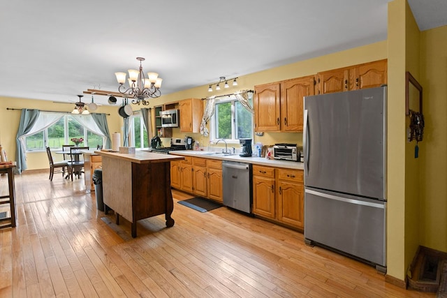 315 Old Tioga St, Wellsboro, PA 16901 - kitchen with stainless steel appliances, a sink, light countertops, a chandelier, and pendant lighting