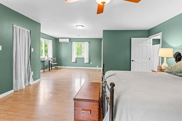 315 Old Tioga St, Wellsboro, PA 16901 - bedroom featuring a wall unit AC, wood finished floors, baseboards, and ceiling fan