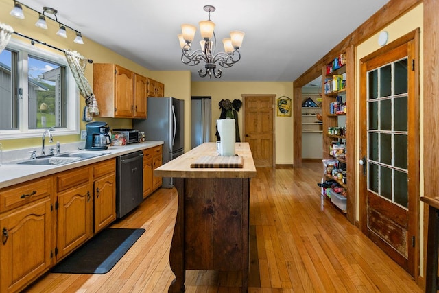 315 Old Tioga St, Wellsboro, PA 16901 - kitchen with appliances with stainless steel finishes, a sink, a center island, a chandelier, and light wood-style flooring