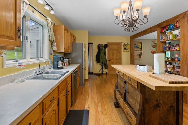 315 Old Tioga St, Wellsboro, PA 16901 - kitchen featuring a sink, butcher block countertops, appliances with stainless steel finishes, light wood-style flooring, and a chandelier