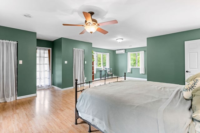 315 Old Tioga St, Wellsboro, PA 16901 - bedroom with a wall mounted AC, baseboards, light wood-type flooring, and ceiling fan