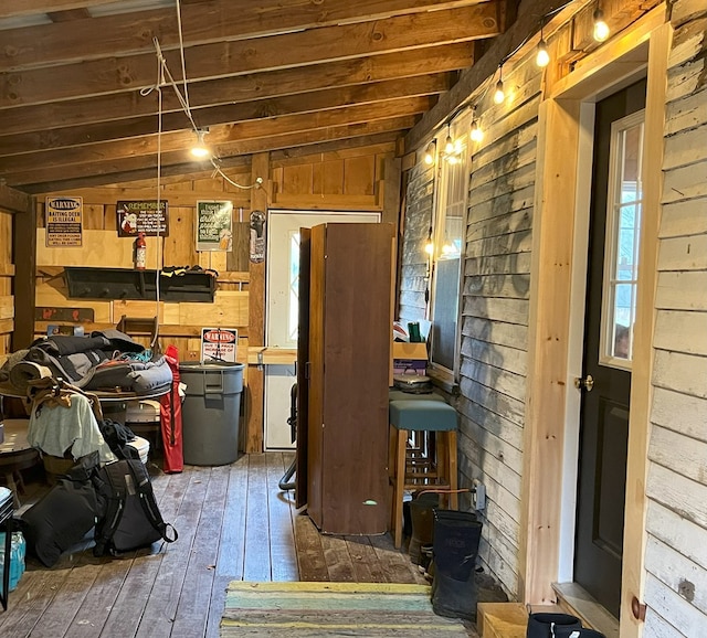 interior space featuring dark hardwood / wood-style flooring and wood walls