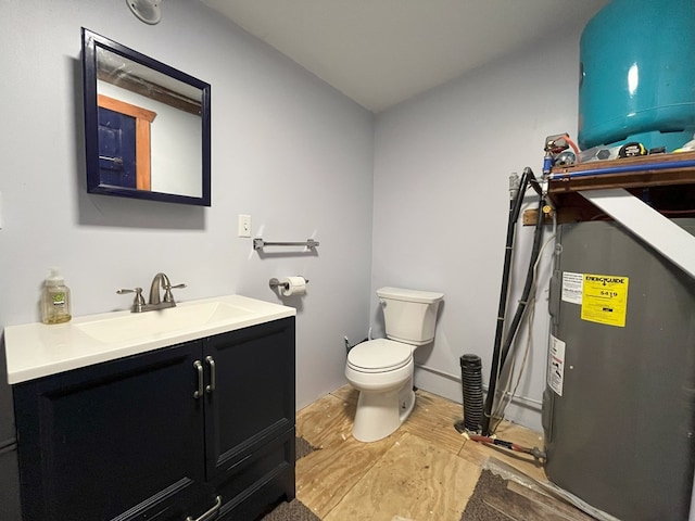 bathroom with vanity, toilet, and wood-type flooring