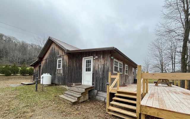 rear view of house featuring a deck