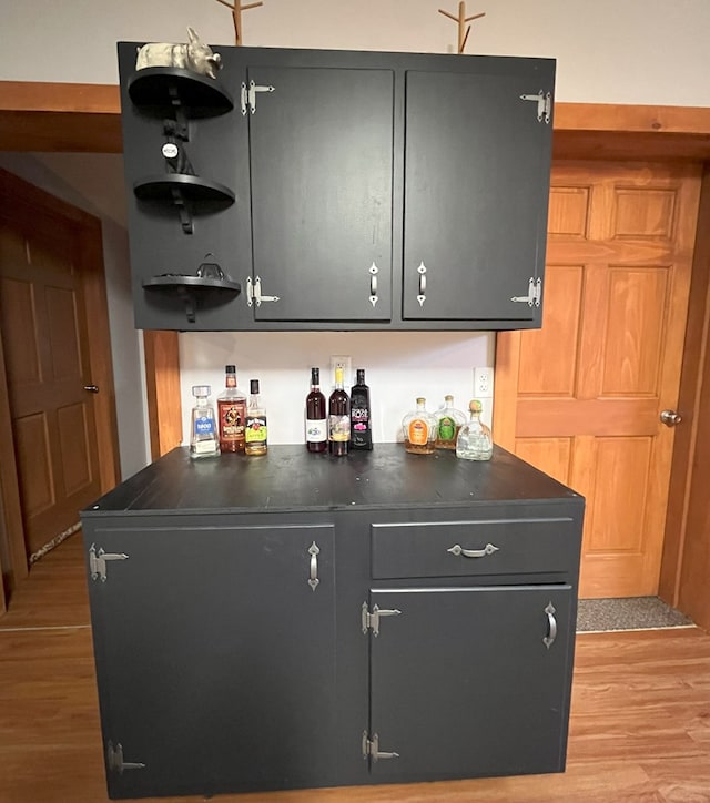 bar featuring light hardwood / wood-style floors