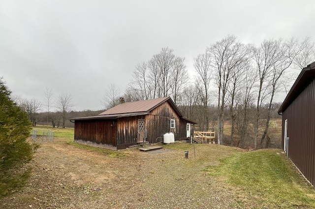 view of side of home featuring an outbuilding