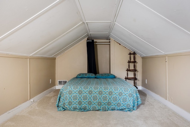 bedroom with carpet floors and lofted ceiling