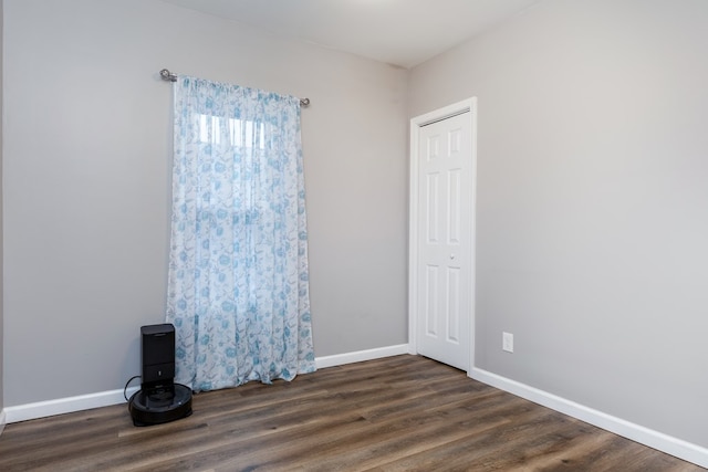 empty room featuring dark hardwood / wood-style flooring