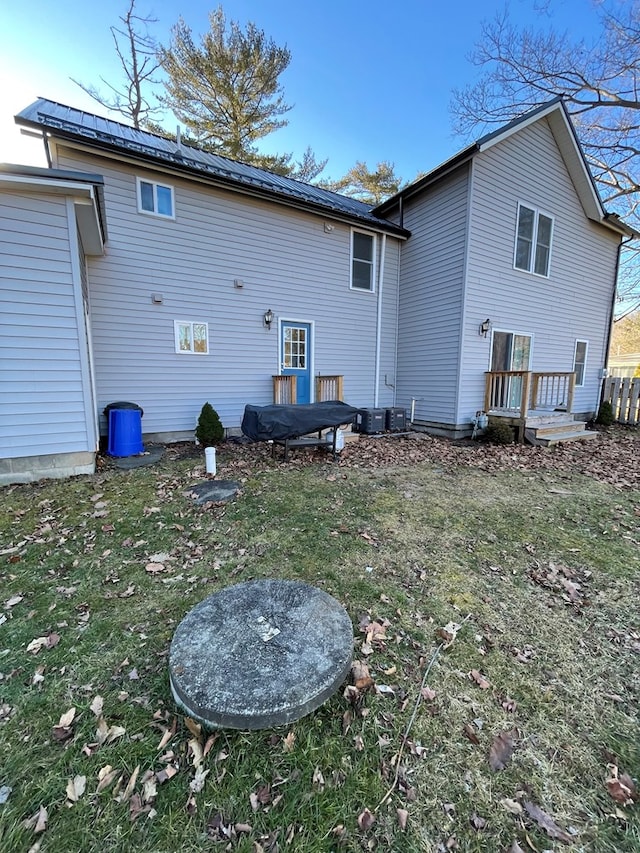 rear view of property featuring a yard