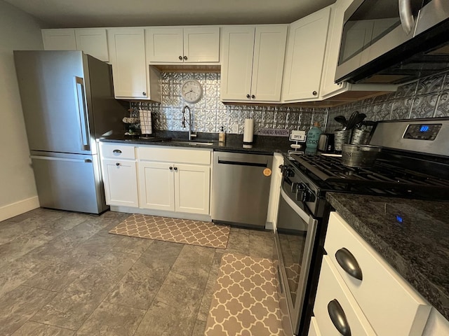 kitchen with white cabinetry, sink, appliances with stainless steel finishes, and tasteful backsplash