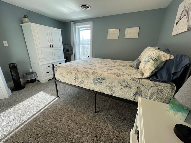 bedroom featuring dark carpet