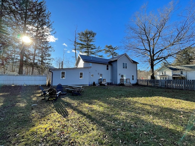 back of house featuring a yard