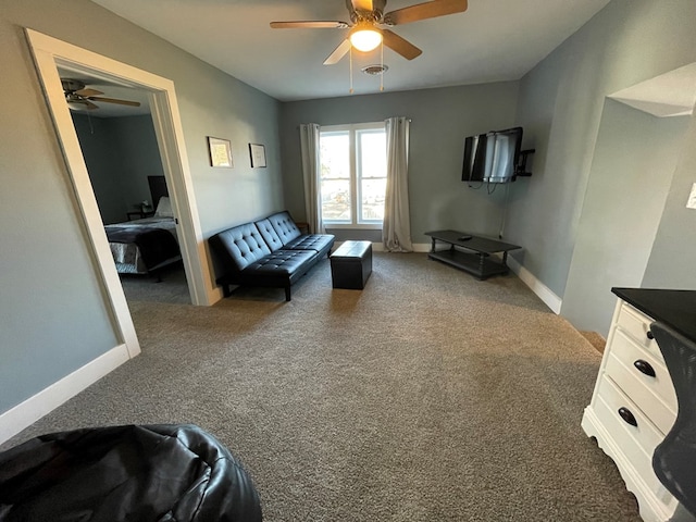 carpeted living room with ceiling fan