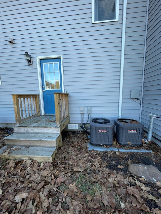 view of exterior entry with central air condition unit